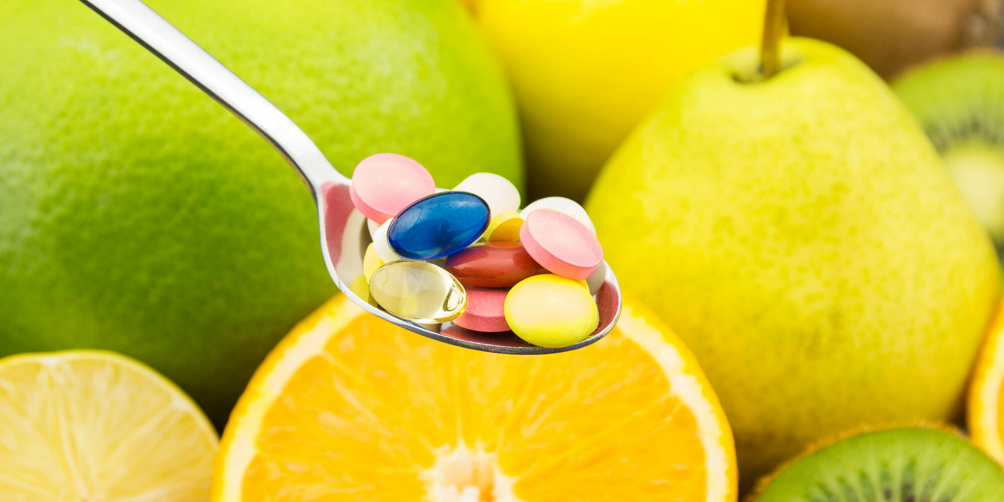 Spoon full of colorful pills